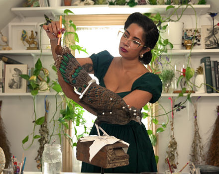 Taxidermist Divya Anantharaman dusts a taxidermied Malaysian peacock pheasant in her eclectic workspace. (photo © SALT Project)