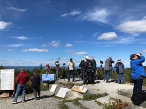 A group of people watch for hawks from the platform at the Pack Mondnoack Raptor Observatory. (photo © Phil Brown)