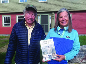 Stephen and Harriet DiCicco stand in front of the Harris Center while holding a copy of Bob Goodby's book, "A Deep Presence." (photo © Lisa Murray)