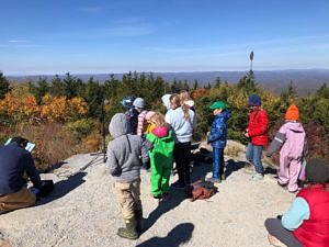 A group of students gather at the Pack Monadnock Raptor Observatory to record a kids' podcast about the fall hawk migration. (photo © Phil Brown)