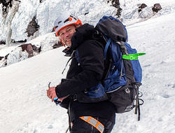 Brian Hutchings, standing on a snowy mountain slope in backcountry skiing gear. (photo courtesy Brian Hutchings)