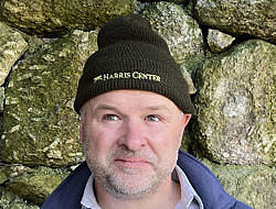A man wearing a Harris Center wool beanie.