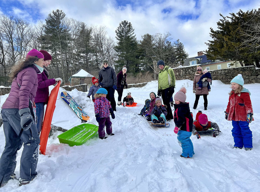 Babies, toddlers, & adults bundled up to sled in the snow (photo © Martha Duffy)