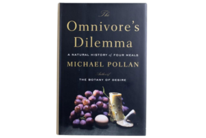 Michael Pollan's The Omnivore's Dilemma book cover. Black with fruit.