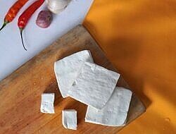 raw tofu on a cutting board
