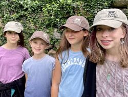 Four summer campers sport the Harris Center's olive green and brown baseball caps. (photo: Audrey Dunn)