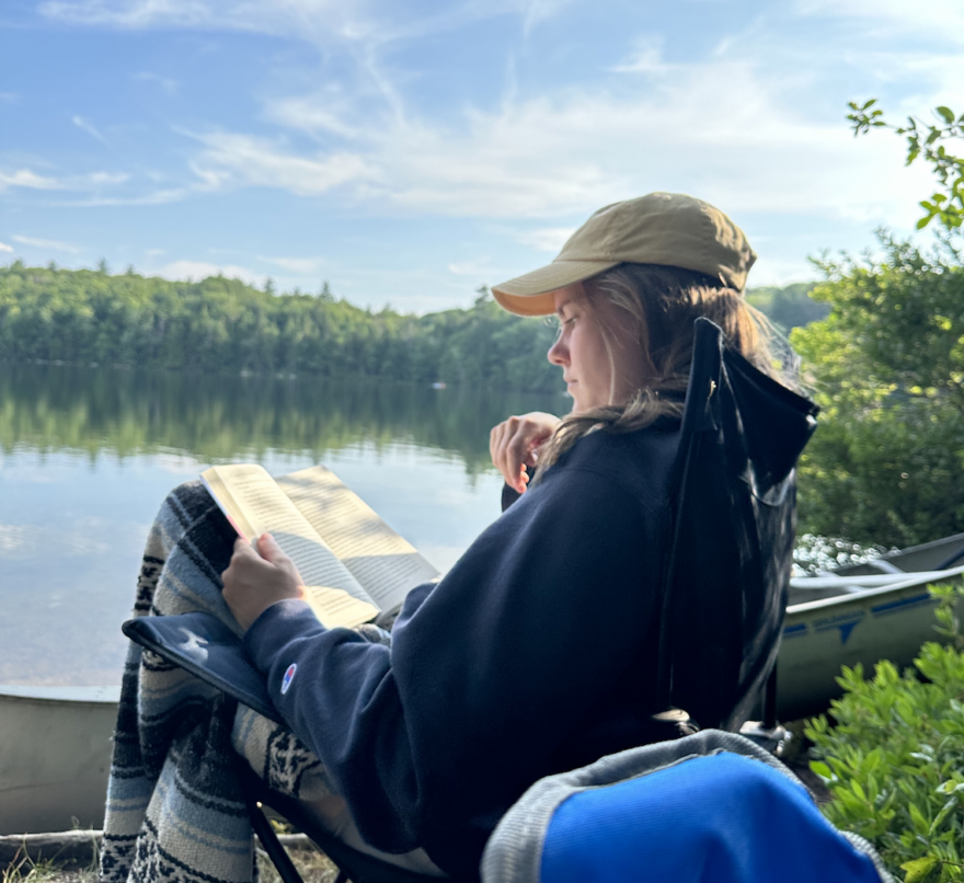 Audrey Dunn reads a book on the banks of sunny Spoonwood. (photo: Alex Schaefer)