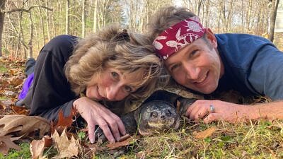 Sy Montgomery and Matt Patterson snuggle with a snapping turtle. (photo © Sy Montgomery)