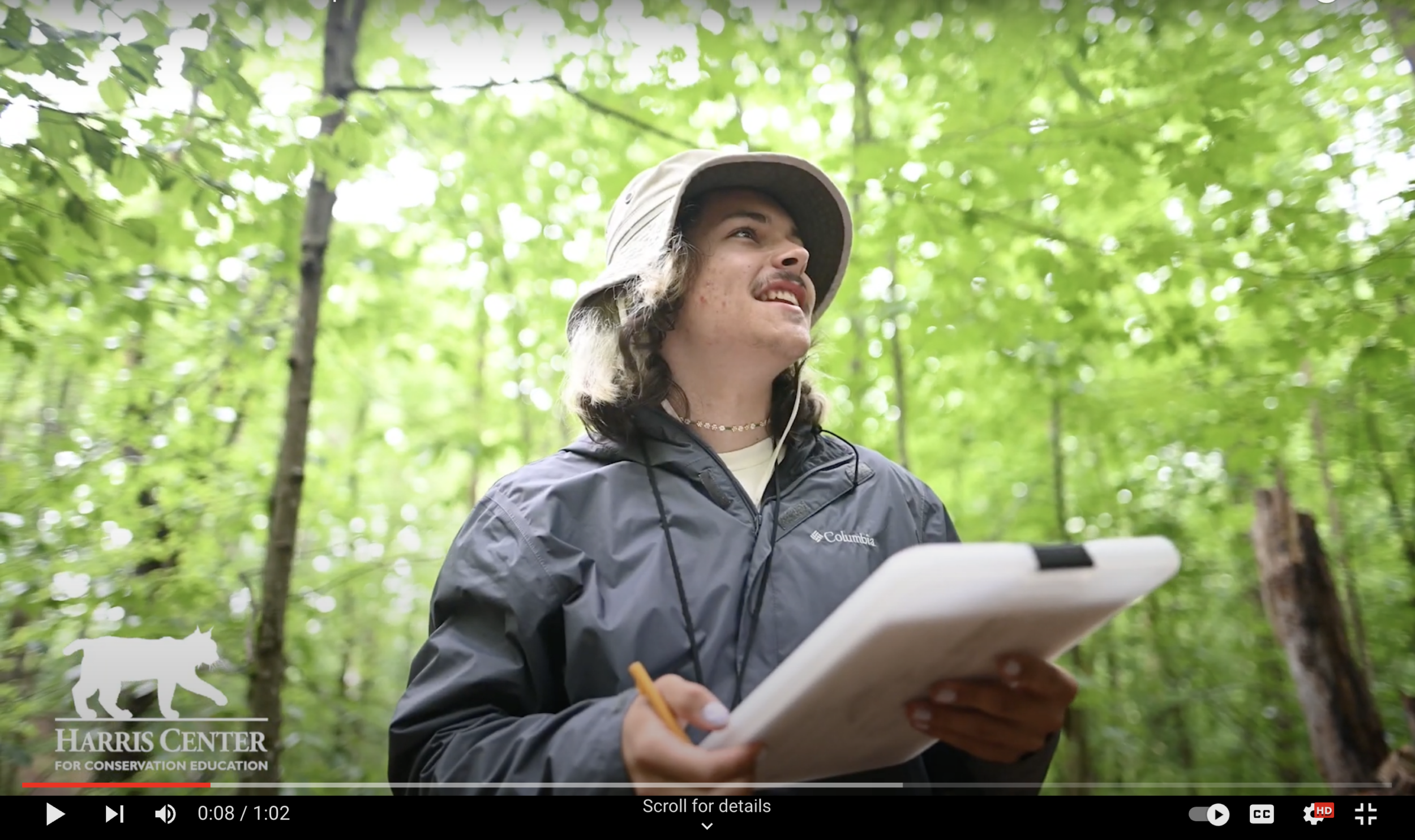 Screenshot from a YouTube video featuring intern Ryan Rotigliano in the forest, holding a clipboard.
