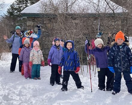 Kara Reynolds and a group of winter campers smile for the camera. (photo © Jaime Hutchinson)