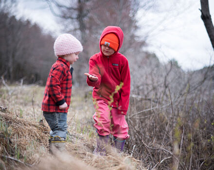 Two young children examine an object on the edge of MacDowell Lake. (photo © Ben Conant)