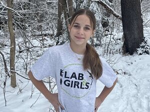 A photo of a girl wearing a LAB GIRLS+ t-shirt.