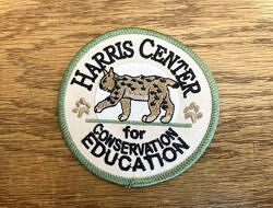 An embroidered patch with a bobcat and the words, 