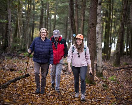 Three hikers in the woods. (photo © Ben Conant)