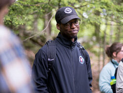 Donta Selden smiles while walking in the woods. (photo © Ben Conant)