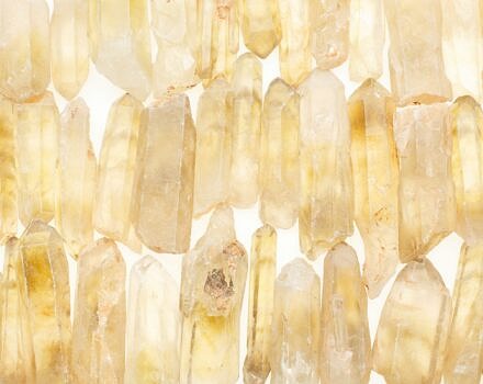 A collection of yellowish quartz crystals. (photo © Benjamin Lehman via Unsplash)