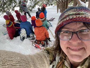 Karen Rent takes a snowy selfie with a group of homeschool students in the background. (photo © Karen Rent)