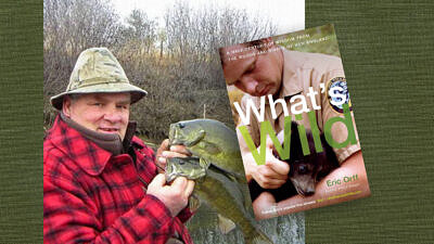 Eric Orff holds two bass fish and the cover of his new book What's Wild (Photo © Eric Orff)