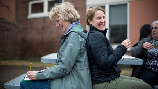 Teachers sitting and smiling during workshop game (Photo © Ben Conant)