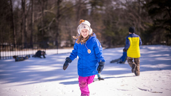 A girl running in the snow (photo © Ben Conant)